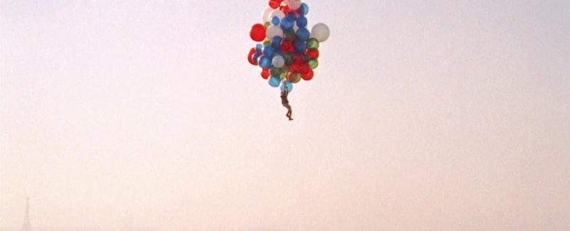 Boy flying in the air with balloons